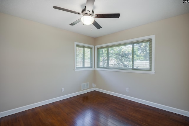 unfurnished room featuring dark hardwood / wood-style floors and ceiling fan