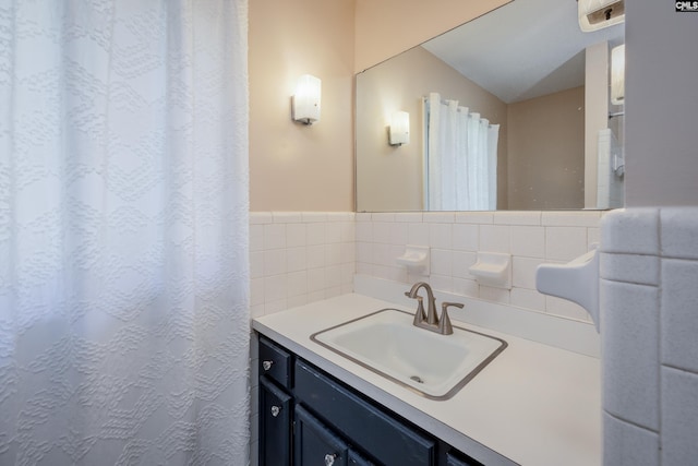 bathroom with vanity and tasteful backsplash