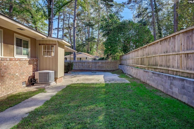 view of yard with a patio and central AC unit