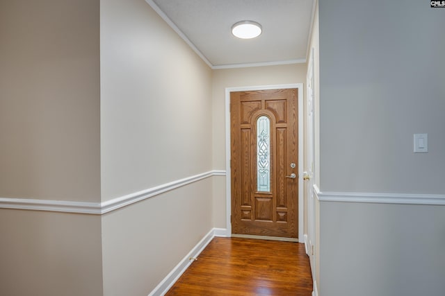 doorway to outside featuring crown molding and dark hardwood / wood-style flooring