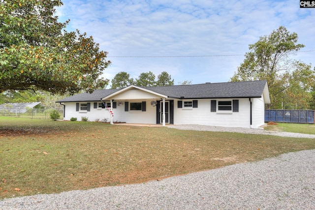 single story home featuring covered porch and a front lawn