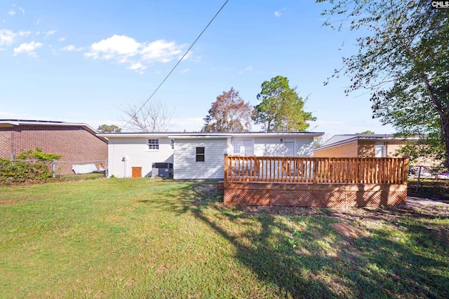 back of house featuring a yard and a deck