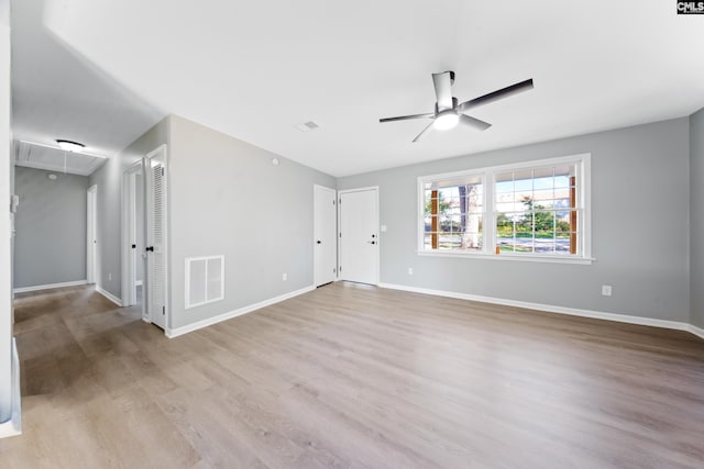 spare room featuring ceiling fan and light hardwood / wood-style flooring