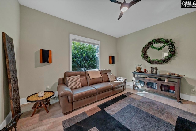 living room with light hardwood / wood-style floors and ceiling fan