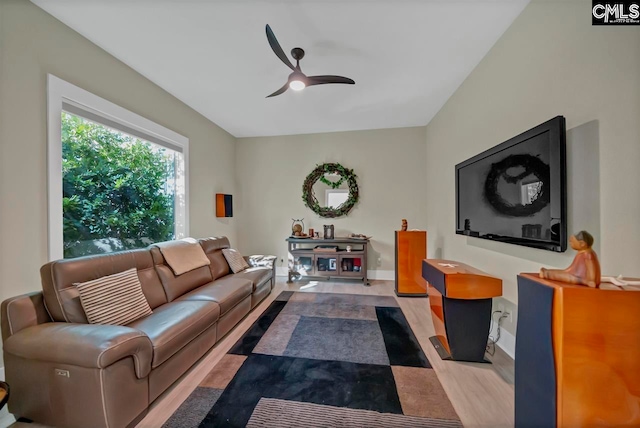 living room with light hardwood / wood-style flooring and ceiling fan