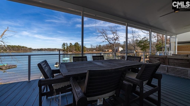 wooden terrace featuring a water view and ceiling fan