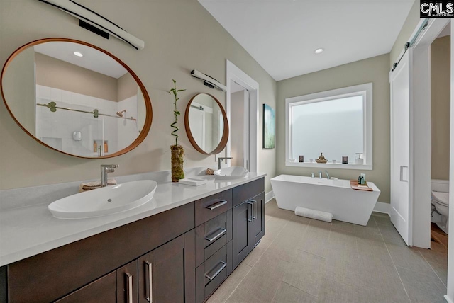 full bathroom featuring vanity, toilet, and shower with separate bathtub