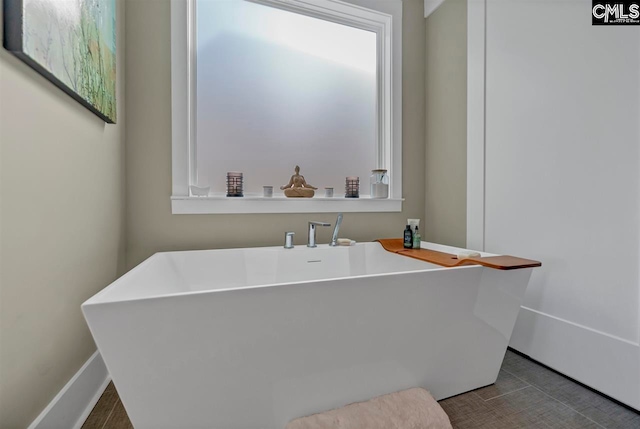 bathroom with a tub to relax in