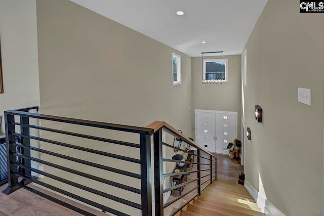 stairs with hardwood / wood-style flooring