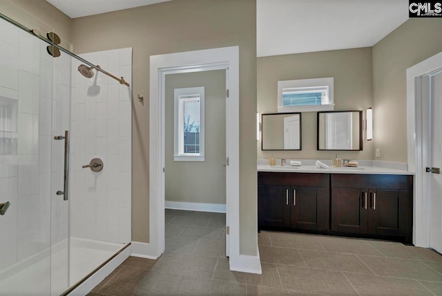 bathroom featuring tile patterned floors, vanity, and walk in shower