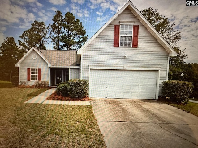 view of property with a front yard and a garage