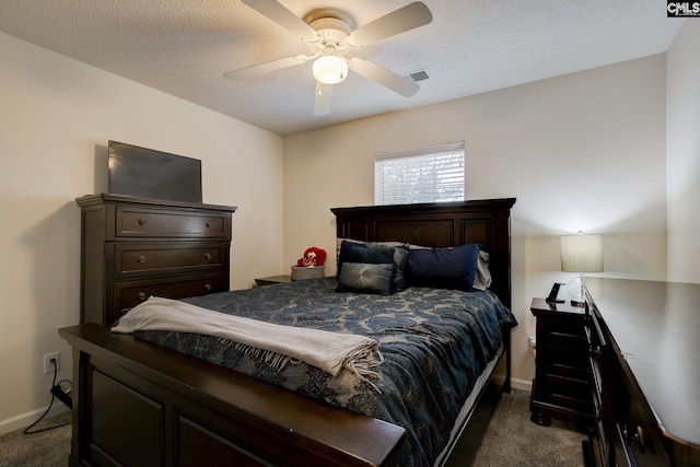 carpeted bedroom featuring ceiling fan and a textured ceiling