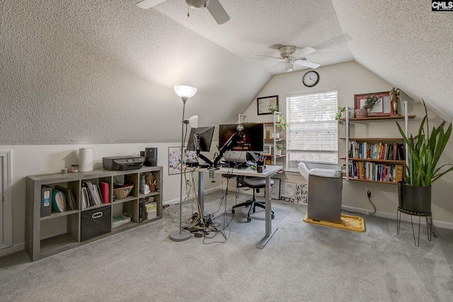 carpeted office featuring ceiling fan, a textured ceiling, and vaulted ceiling