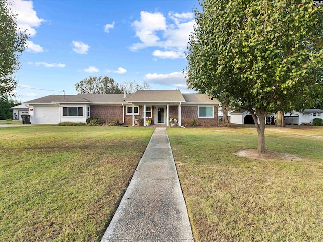 ranch-style house featuring covered porch, a garage, and a front lawn