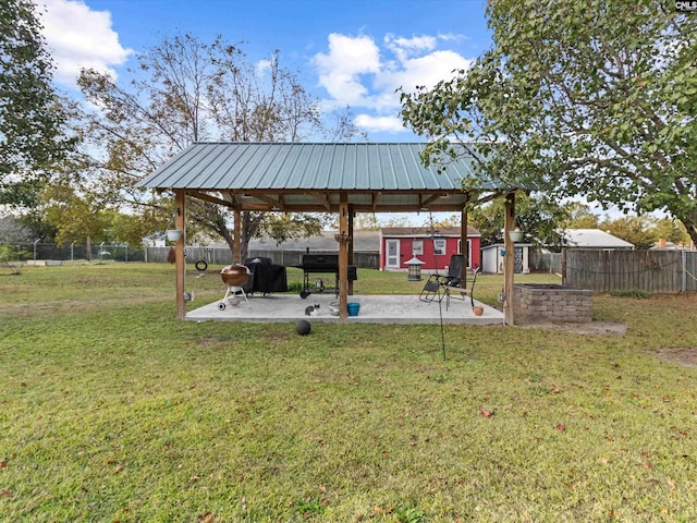 view of yard featuring an outdoor structure and a patio