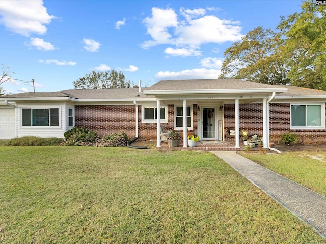 ranch-style house featuring a garage, covered porch, and a front lawn