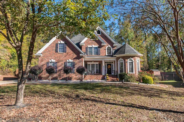 view of front of house with a porch and a front lawn