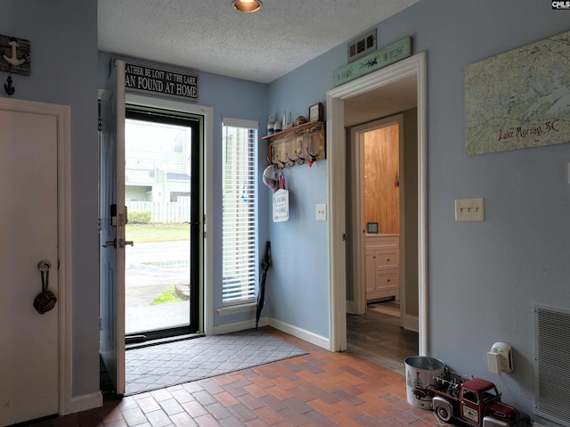 entryway featuring a textured ceiling