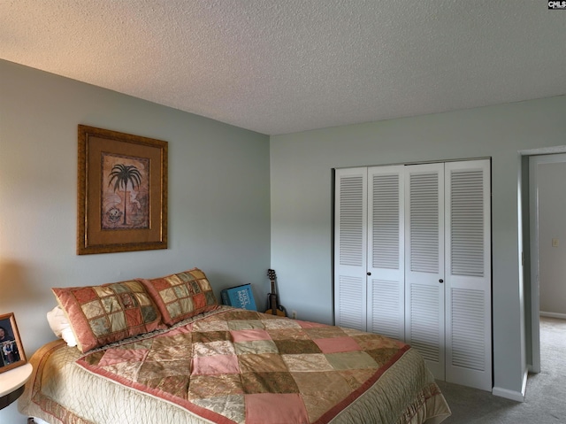 carpeted bedroom featuring a textured ceiling and a closet