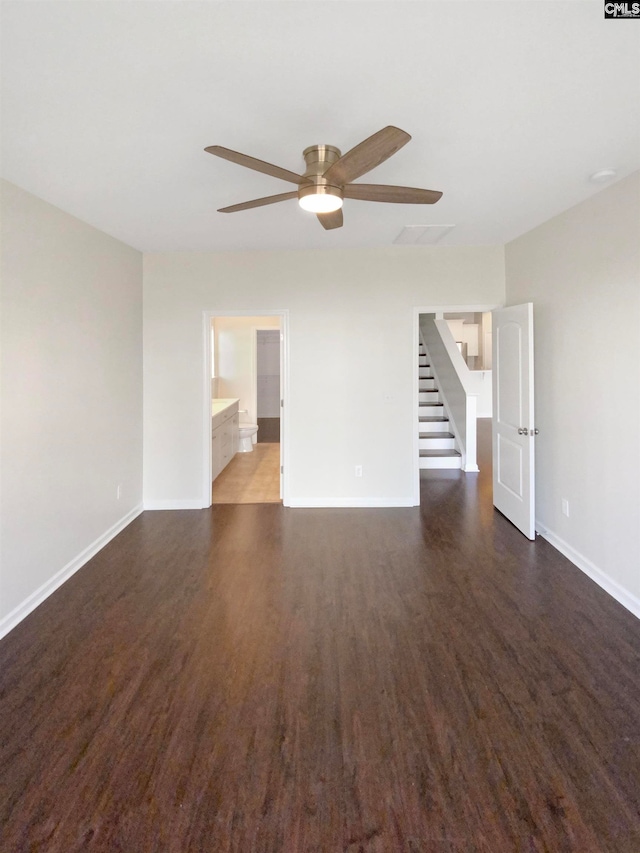 empty room with ceiling fan and dark wood-type flooring