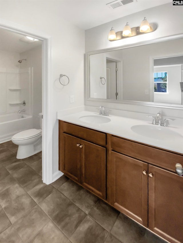 full bathroom featuring tile patterned flooring, vanity,  shower combination, and toilet