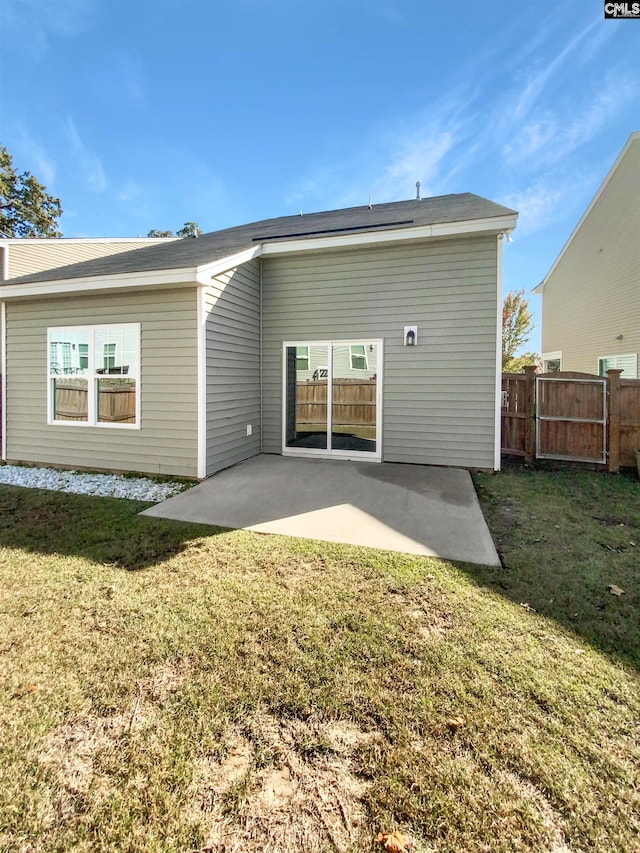 rear view of house with a patio area and a yard