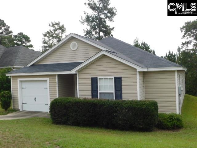 view of front of property featuring a front lawn and a garage