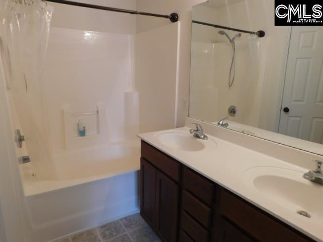 bathroom with vanity and shower / tub combo with curtain