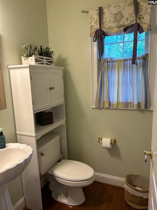 bathroom featuring wood-type flooring and toilet