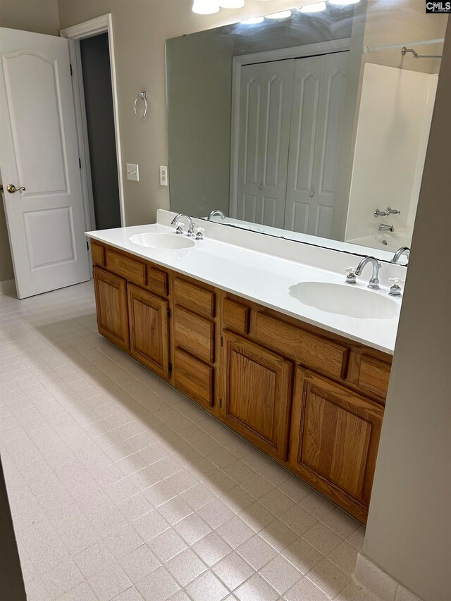 bathroom featuring tile patterned flooring, vanity, and shower / bath combination