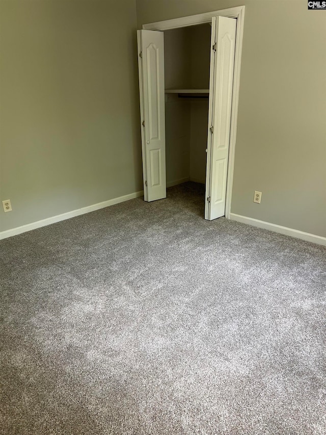 unfurnished bedroom with a closet and carpet