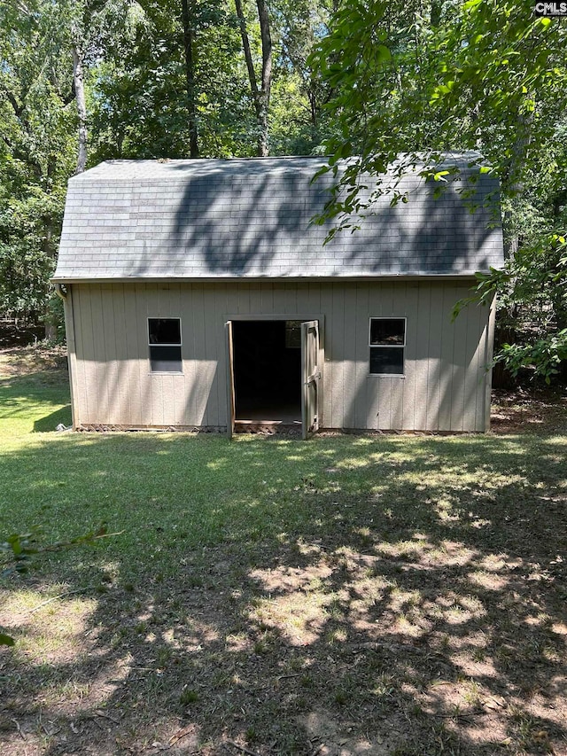 view of outbuilding with a yard