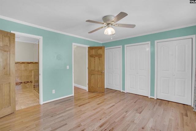 unfurnished bedroom featuring light wood-type flooring, two closets, ceiling fan, and ornamental molding