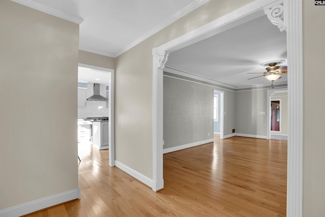 unfurnished room featuring ceiling fan, light hardwood / wood-style floors, and ornamental molding