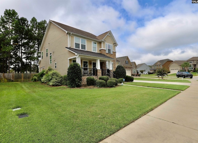 craftsman house featuring a porch, a front yard, and a garage