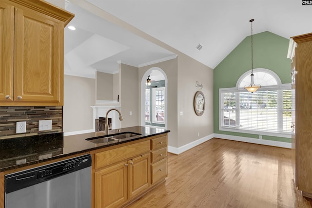 kitchen featuring pendant lighting, dishwasher, dark stone counters, sink, and light hardwood / wood-style flooring