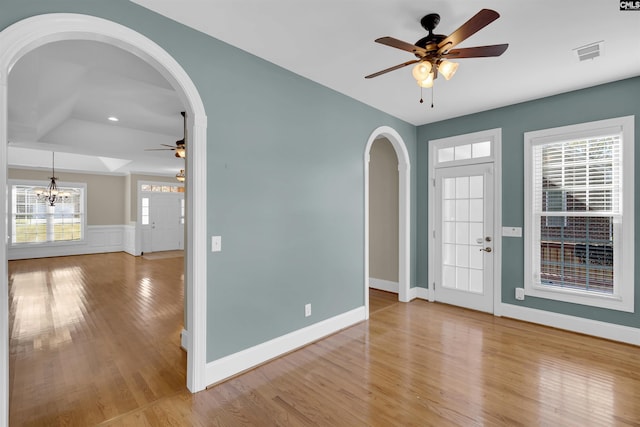 foyer featuring ceiling fan with notable chandelier and light wood-type flooring