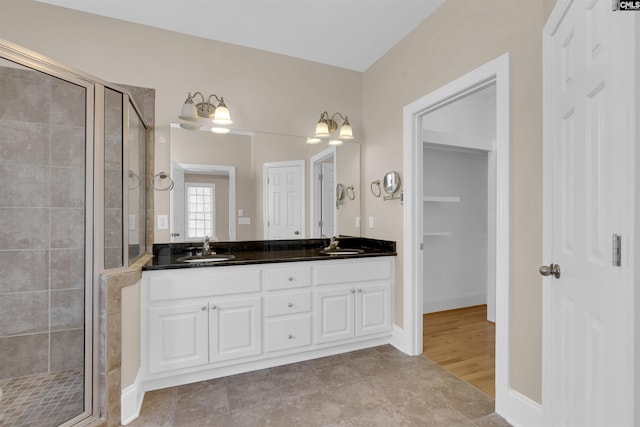 bathroom featuring vanity, wood-type flooring, and walk in shower