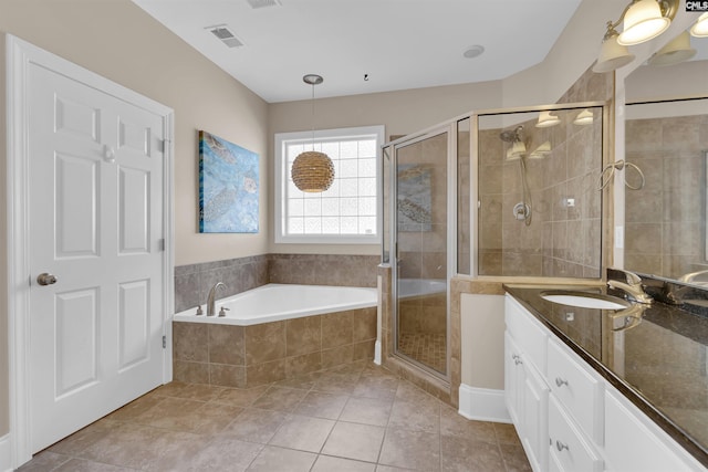 bathroom featuring tile patterned floors, vanity, and plus walk in shower