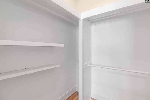 walk in closet featuring hardwood / wood-style flooring