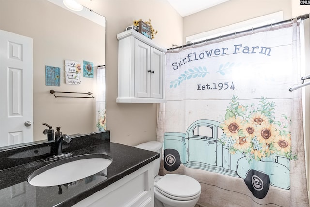 bathroom featuring vanity and toilet