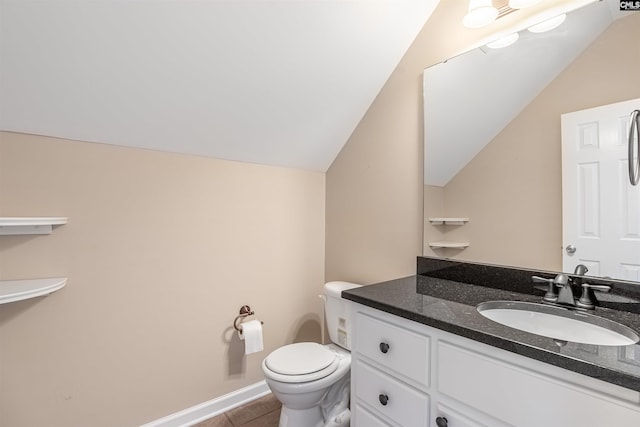 bathroom with tile patterned floors, vanity, toilet, and lofted ceiling