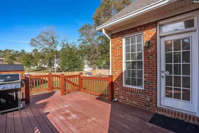 wooden terrace with a grill