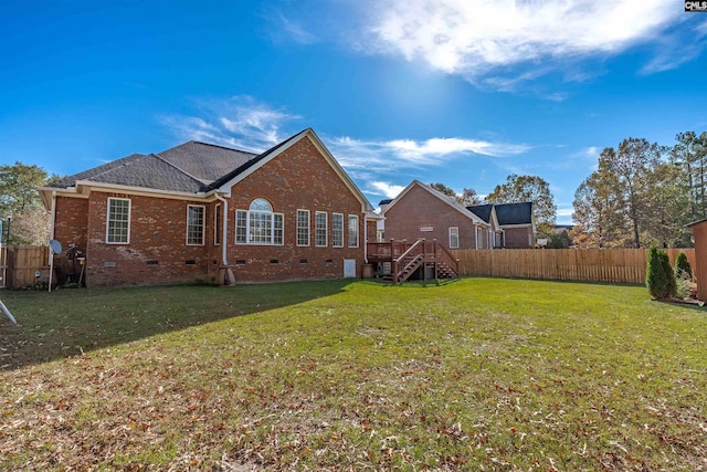 back of house featuring a yard and a wooden deck