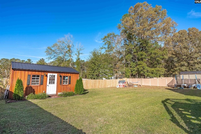 view of yard with a storage shed and a trampoline