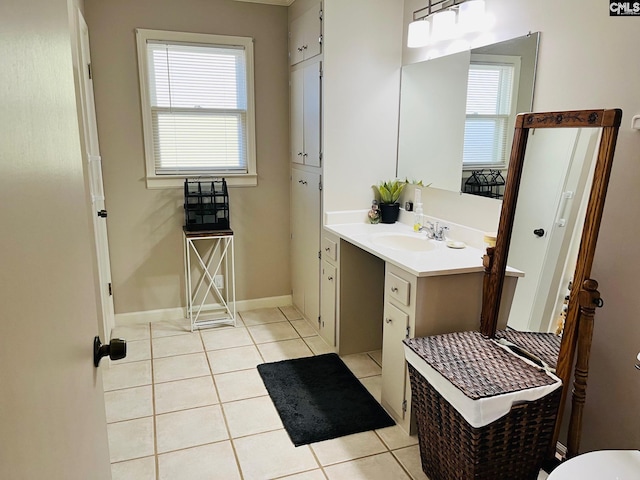 bathroom featuring a healthy amount of sunlight, tile patterned floors, and vanity