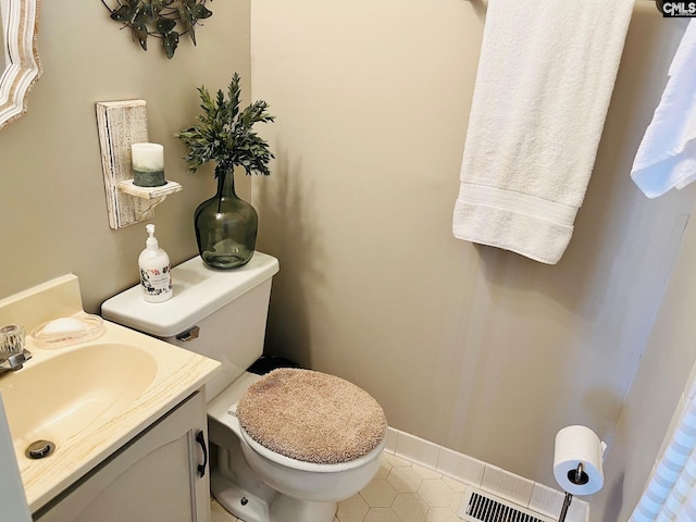 bathroom featuring tile patterned floors, toilet, and vanity