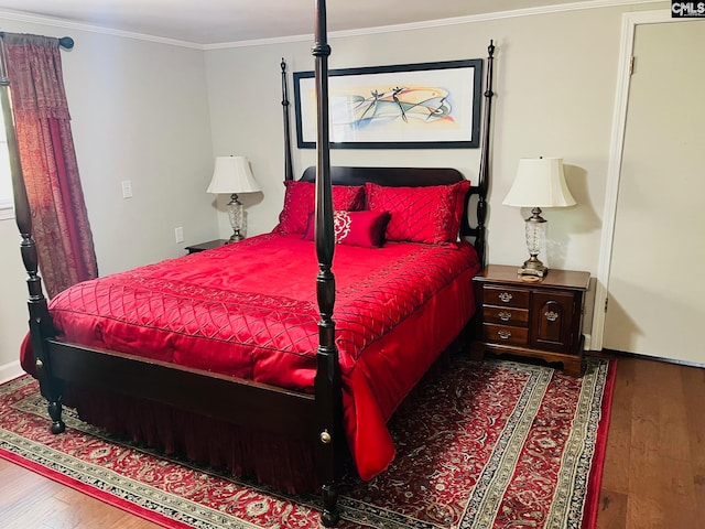 bedroom with crown molding and hardwood / wood-style floors