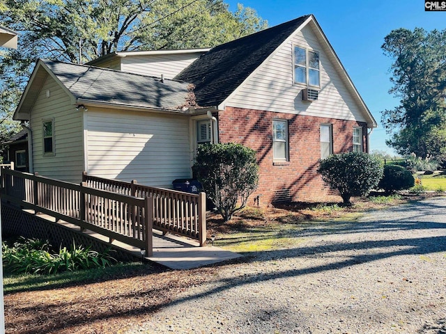 view of property exterior with a deck