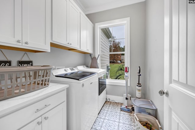 clothes washing area with cabinets, independent washer and dryer, light tile patterned floors, and ornamental molding